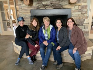 Women's Auxiliary members sitting on Founders Hall fire hearth during retreat